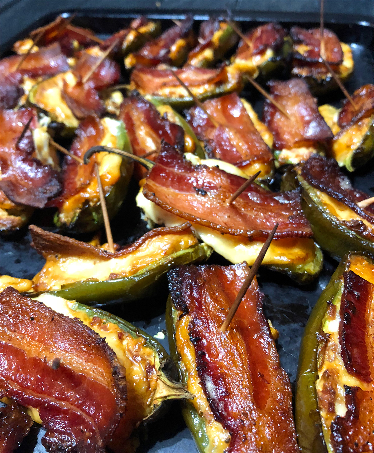Jalepeno Poppers Bacon Slices on a Peacemaker Grill Andrew Parent
